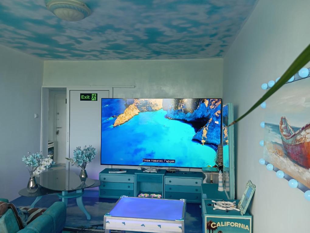 a living room with a large flat screen tv at Apartament ALBATROS in Burgas City