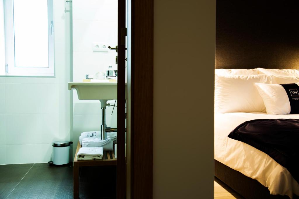 Postel nebo postele na pokoji v ubytování Villa Prime Hotel