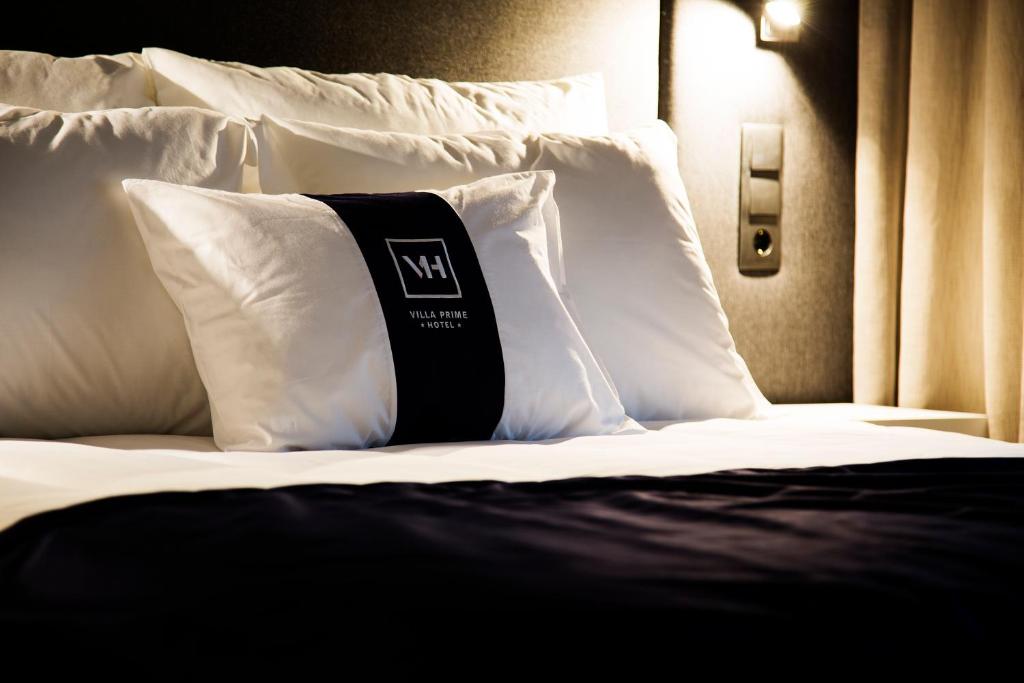 Postel nebo postele na pokoji v ubytování Villa Prime Hotel