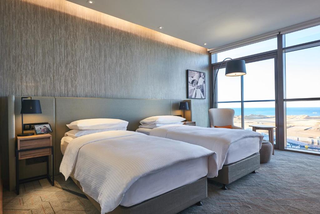 Postel nebo postele na pokoji v ubytování Mysk Al Mouj Hotel