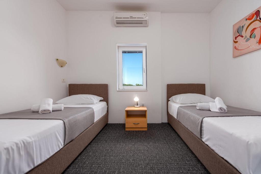 Postel nebo postele na pokoji v ubytování Villa Dandelion ZadarVillas