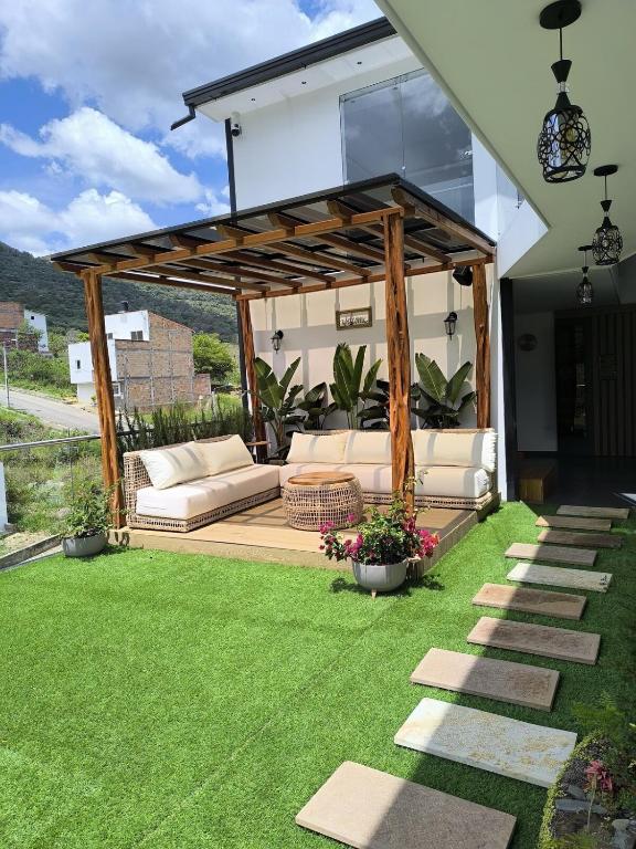 a gazebo with a couch on a lawn at Robles Penthouse in San Gil