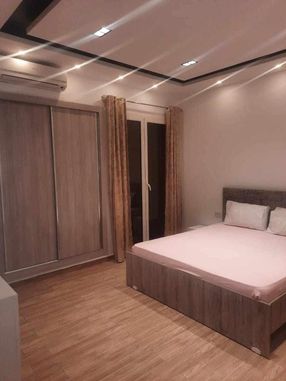 a bedroom with a large bed in a room at EIina in Zarzis