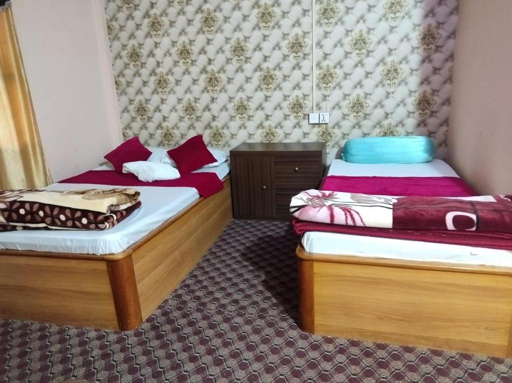 Postel nebo postele na pokoji v ubytování Dayglow inn , BHADRAPUR