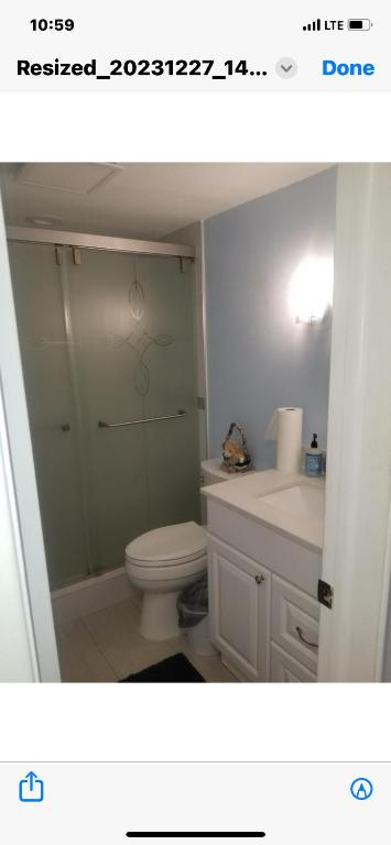 a bathroom with a shower and a toilet and a sink at Florida Condo By the Beach in JFK Medical Center Incorporated Heliport