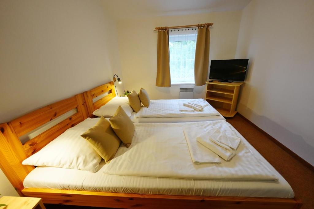 Postel nebo postele na pokoji v ubytování Resort Ohrada