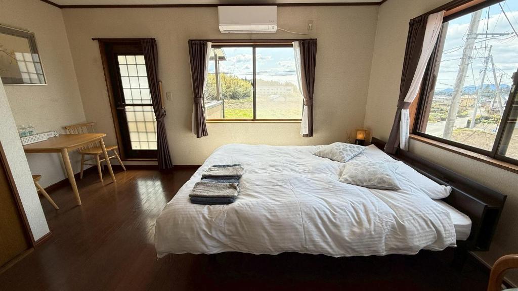 Postel nebo postele na pokoji v ubytování Kitayama Fuji View House