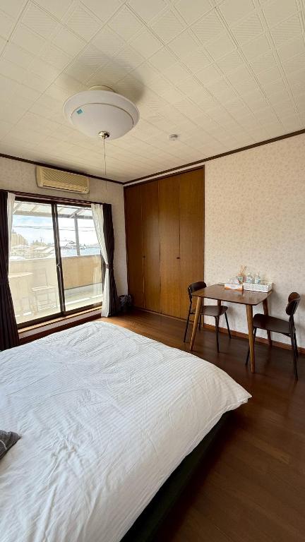Postel nebo postele na pokoji v ubytování Kitayama Fuji View House