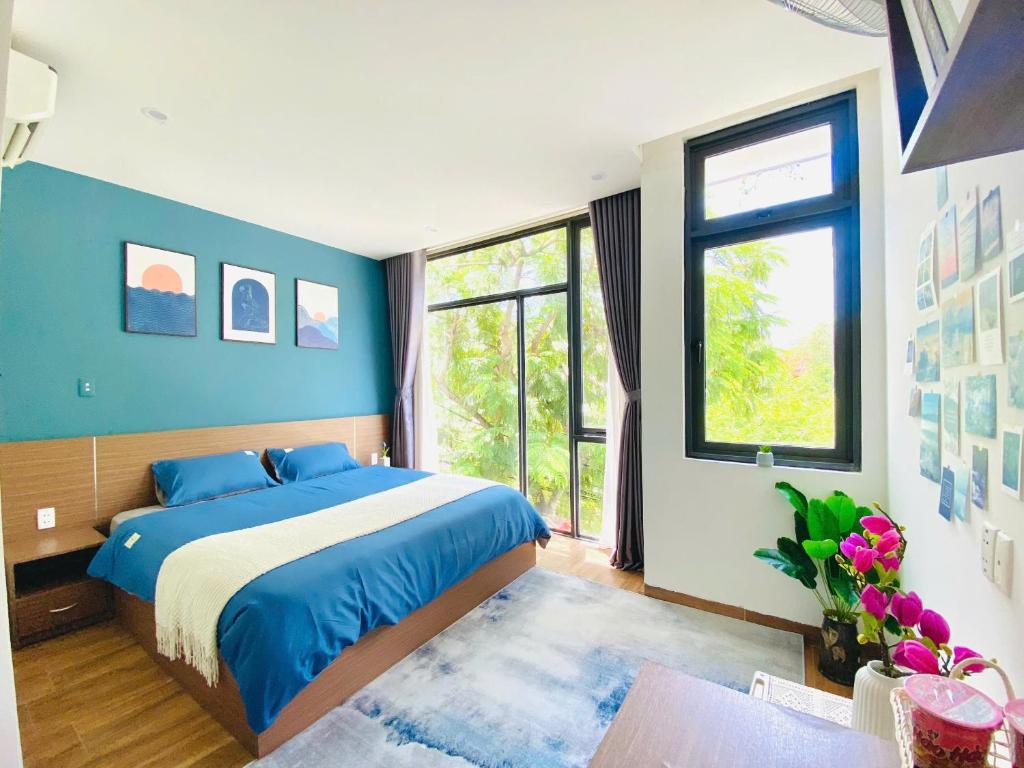 a bedroom with a bed and a large window at Pina Home in Da Nang
