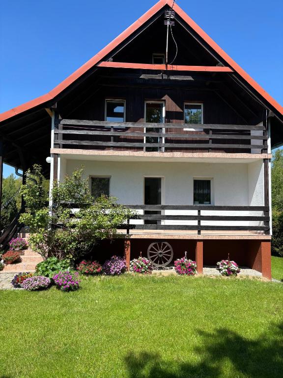 a large house with a red roof at Mazurskie Zacisze - sauna, jacuzzi, kominek in Trygort