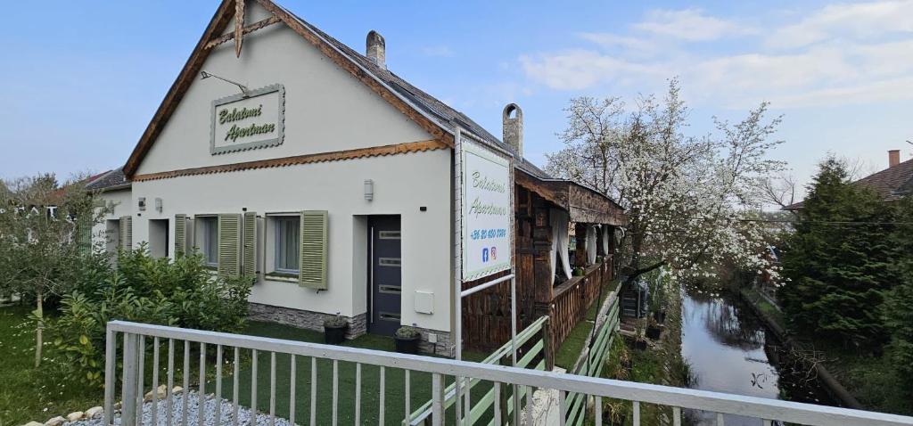 a building that is next to a river at Balatomi Apartman in Balatonföldvár