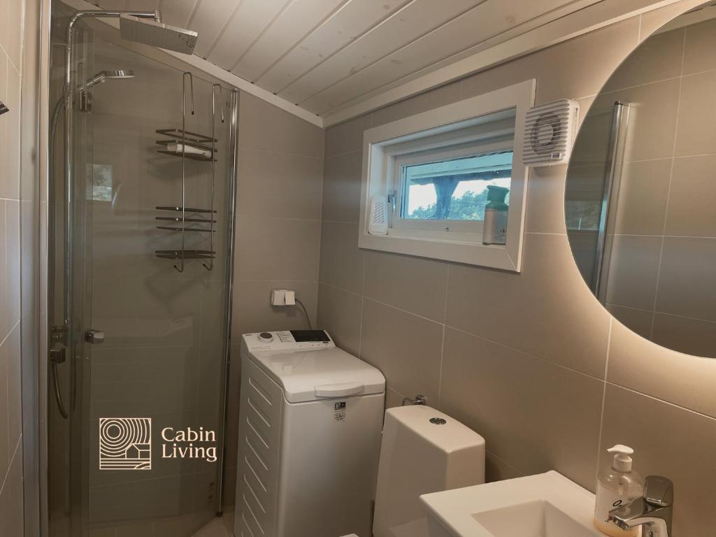 a bathroom with a toilet and a sink and a shower at Family-Friendly Coastal Getaway Near Kragerø 3 in Kragerø