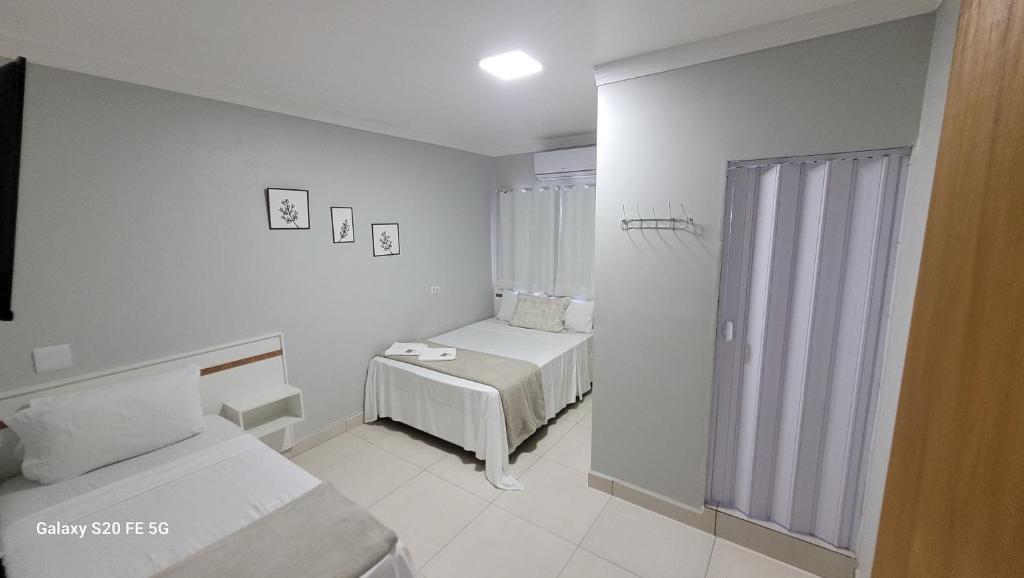 Postel nebo postele na pokoji v ubytování Hotel Hiperion Maringá