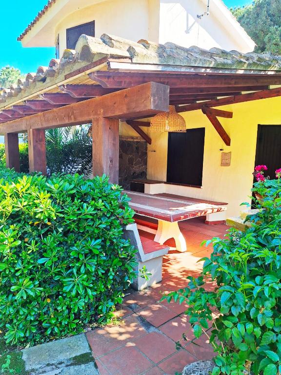 a patio with a wooden bench under a pavilion at Casa Agostina in Pula