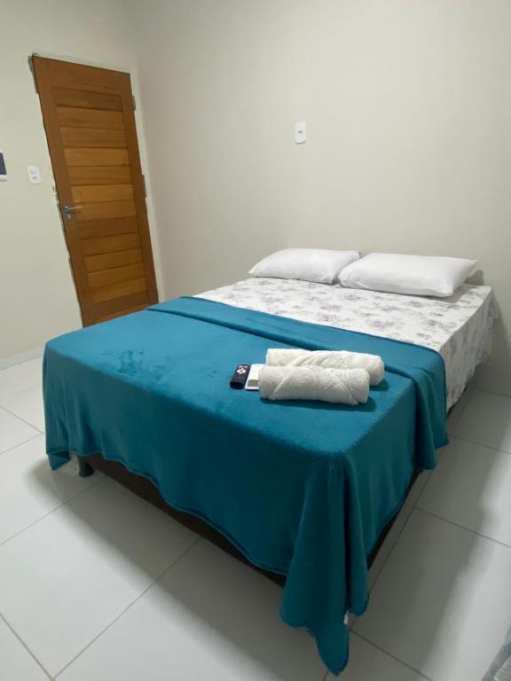 a bedroom with a bed with two towels on it at Hotel Maria Araújo in Arapiraca