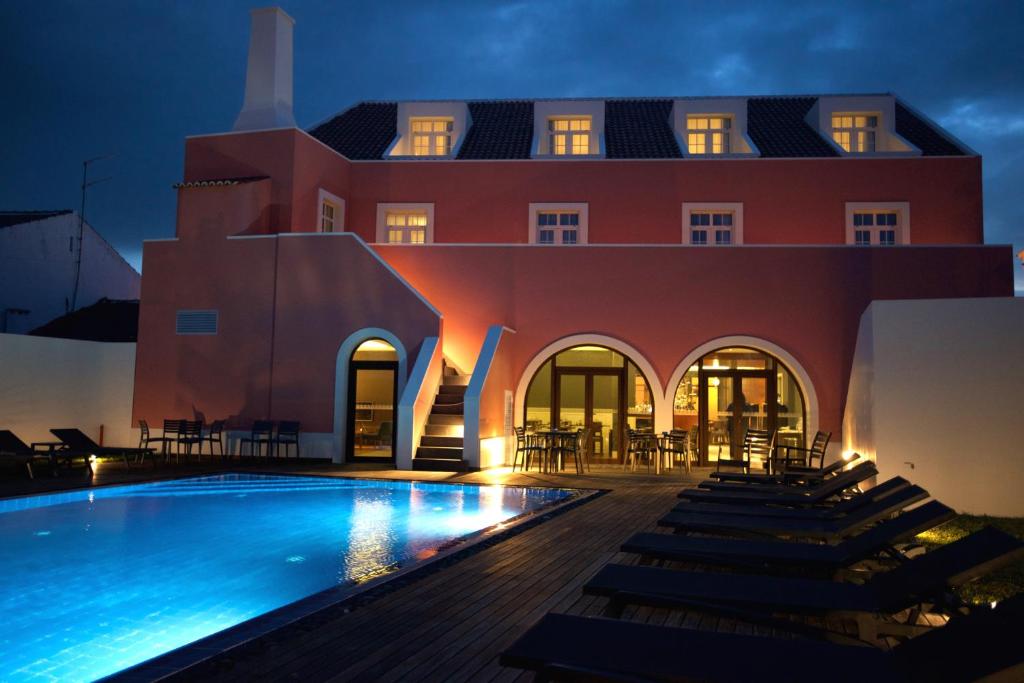 a resort with a swimming pool at night at Charming Blue in Vila do Porto