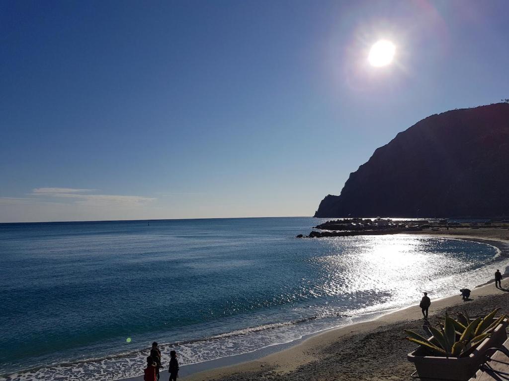 a group of people walking on the beach at Casa Milanesi in Monterosso al Mare