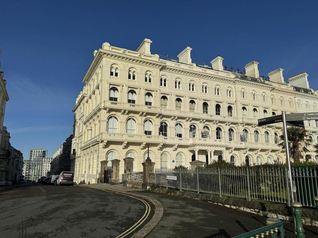 a large white building with a fence in front of it at Edenhurst By Pureserviced in Plymouth