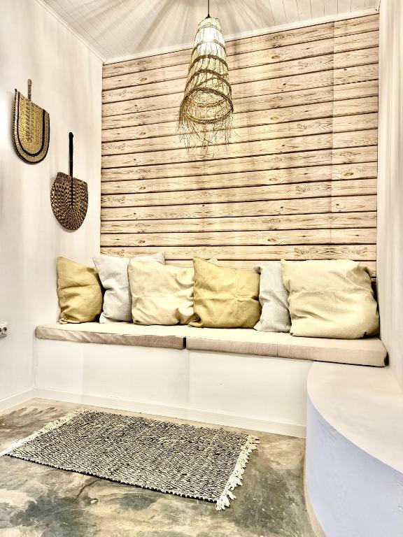 a couch in a room with a wooden wall at Terra Massa in Sinemorets