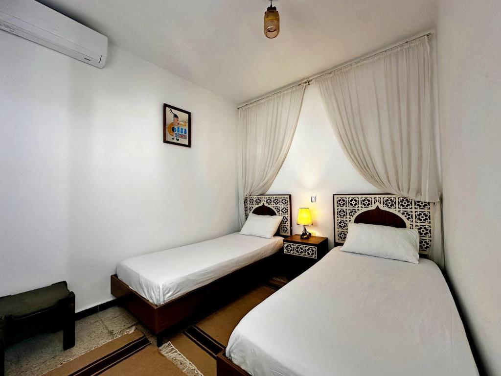 Postel nebo postele na pokoji v ubytování Hotel Paris