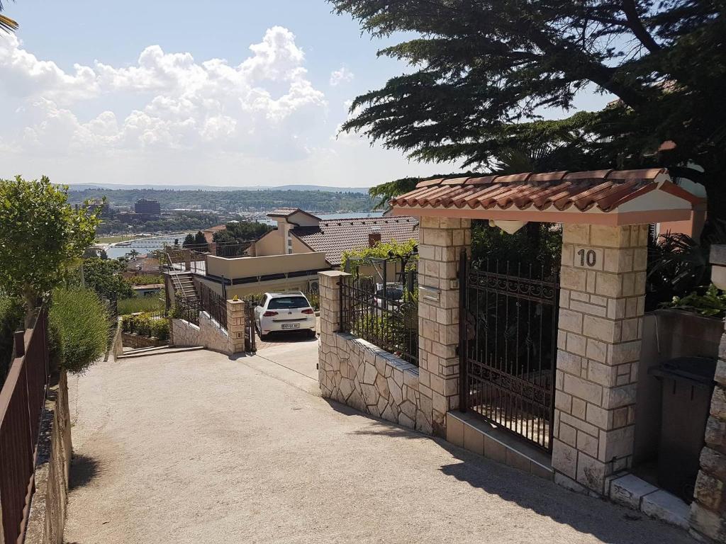 a house with a gate with a view of a street at Apartments Miklus in Portorož