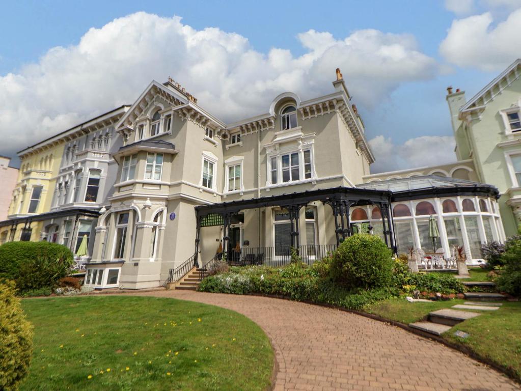a large white house with a brick driveway at Ismay Lounge Apartment- Titanic Interest in Liverpool