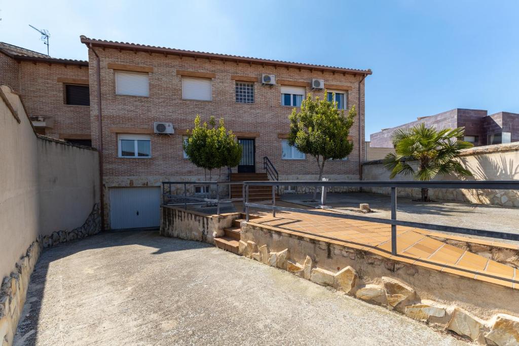 a brick building with a gate in front of it at Callejon Del Pozo in Gálvez