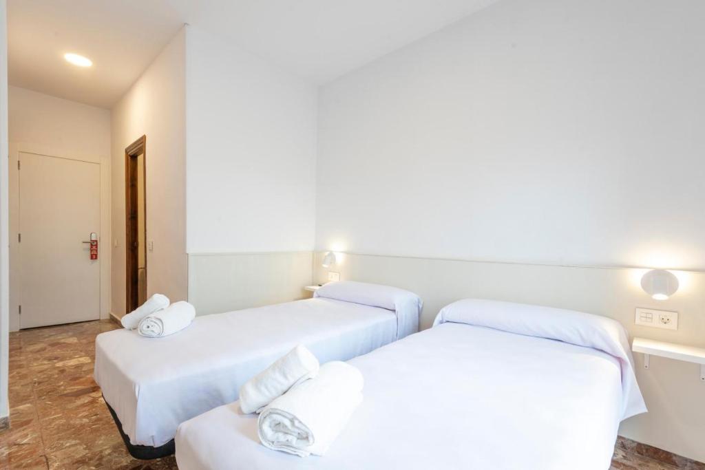Postel nebo postele na pokoji v ubytování Hostal La Vía Verde