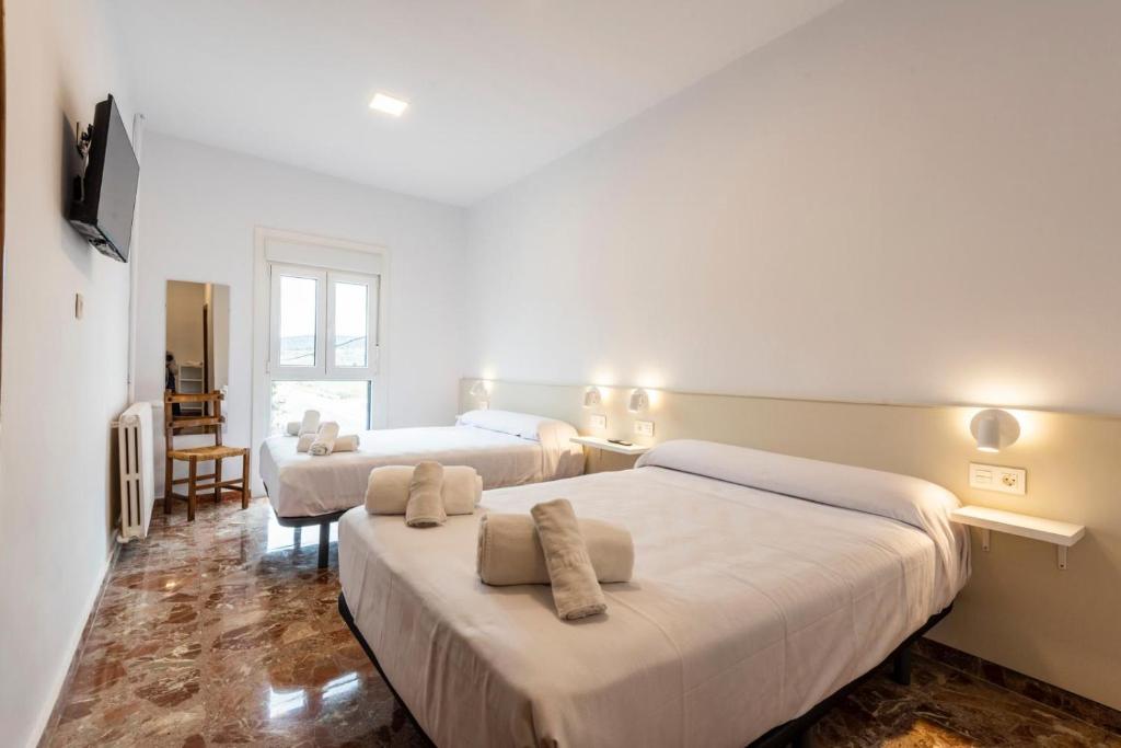 Postel nebo postele na pokoji v ubytování Hostal La Vía Verde