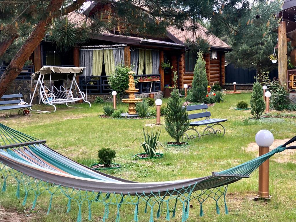 a hammock in a yard in front of a house at Казковий Світязь in Szack
