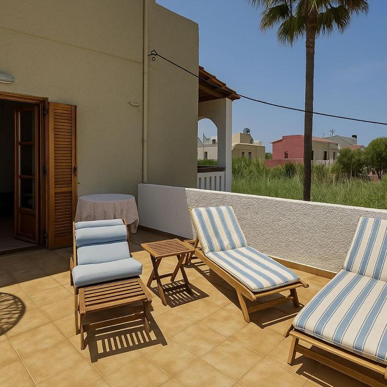two chairs and a table on a patio at Nicolas Beach in Palaiochora