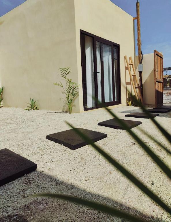 a shadow of a building with some mats in front of it at Macarena Paredon in El Paredón Buena Vista