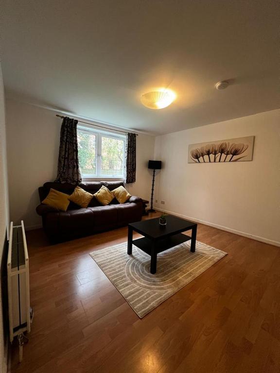 a living room with a couch and a coffee table at Lovely 2 bedroom Back Hilton near PJ Live in Aberdeen