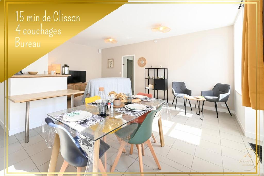 a kitchen and dining room with a glass table and chairs at La Sérénade des Mauges Charme Nature Détente in Montfaucon