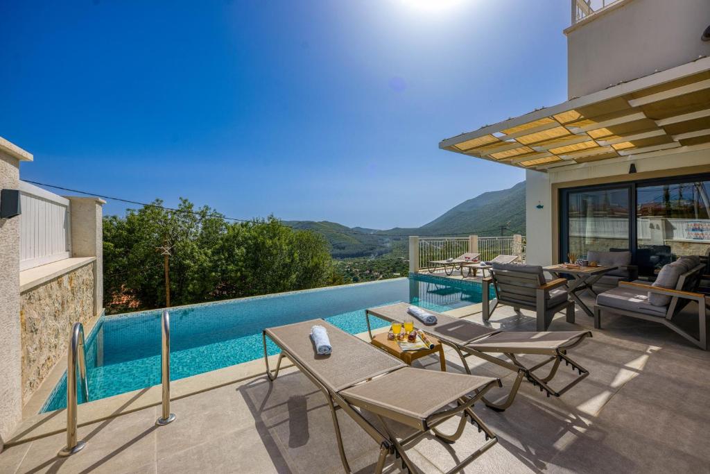 a patio with tables and chairs and a swimming pool at Çukurbağ Köyü Doğa Manzaralı Villa Oriente in Kas