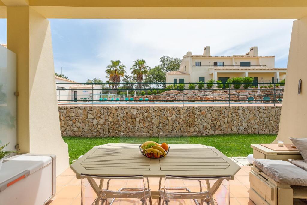 a table with a bowl of fruit on a patio at Glenridge Resort By Albufeira Rental in Albufeira