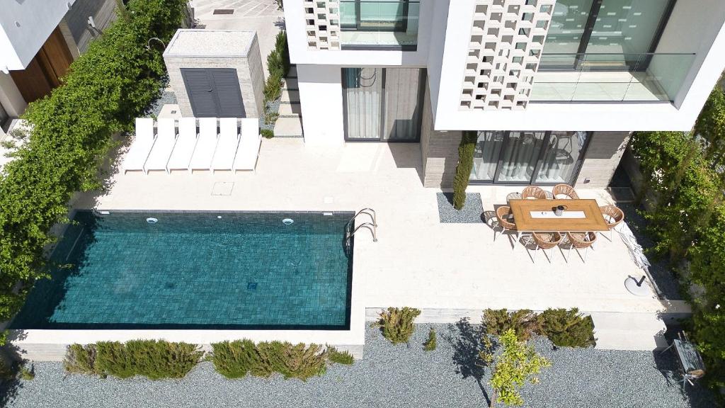 an aerial view of a house with a swimming pool at Oasis Villa 6 in Khlorakas