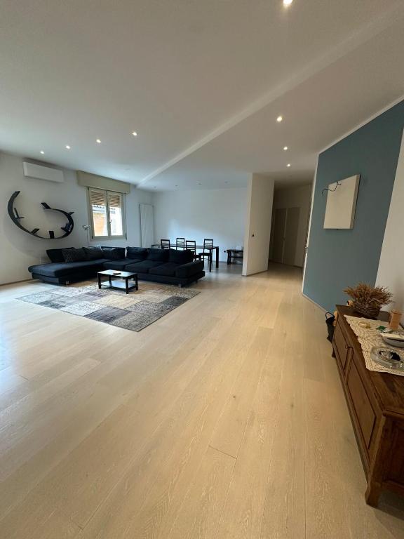 a large living room with a couch and a table at StayQ Appartamento elegante in centro in Castel San Pietro Terme