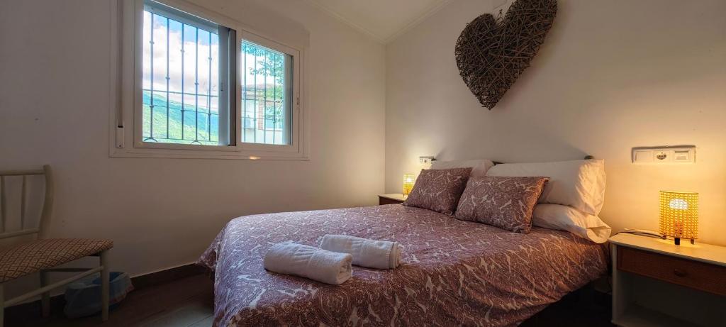 a bedroom with a bed with two pillows on it at Casa del Castillo by Naturadrada in La Adrada