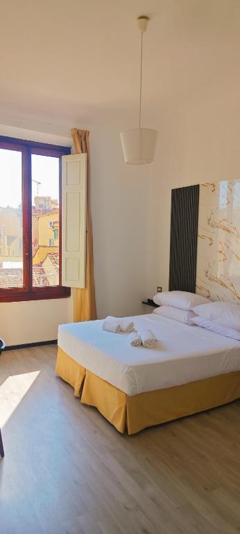 Ένα ή περισσότερα κρεβάτια σε δωμάτιο στο Leone XIV Firenze