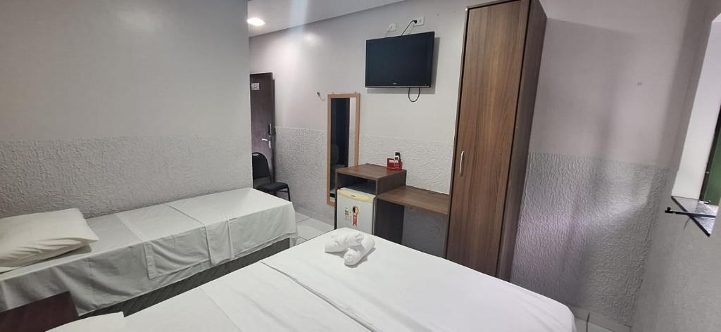 a hospital room with two beds and a tv at Hotel Borari in Alter do Chao