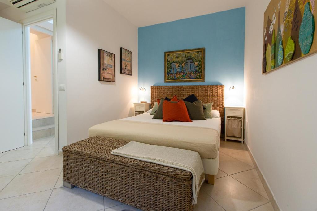 a bedroom with a large bed with orange pillows at Il Nido di Montiano, giardino, natura e relax in Magliano in Toscana