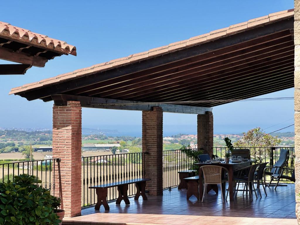 a pavilion with tables and chairs on a deck at El Tirao de Suesa - 34800 in Suesa
