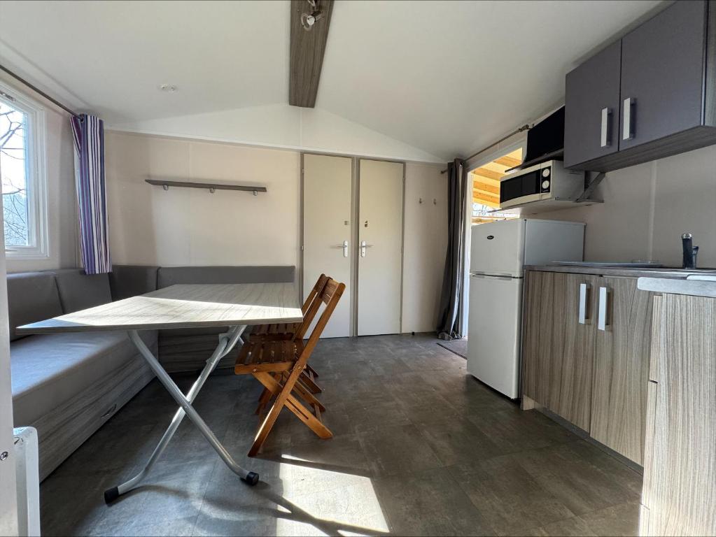 a small kitchen with a desk and a table at Au coeur de la pinède in Camiers