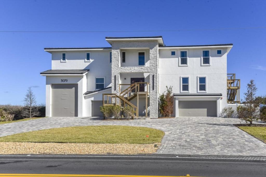 a large white house with a driveway at The White House on Flagler Beach - Unit 23 in Flagler Beach