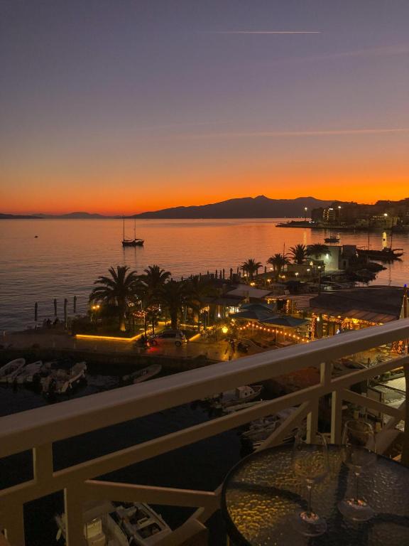 a view of the ocean at sunset from the balcony of a resort at Sun N Blue Hotel in Sarandë