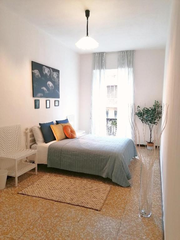 a bedroom with a bed and a large window at La Cà De Zan in Mezzegra