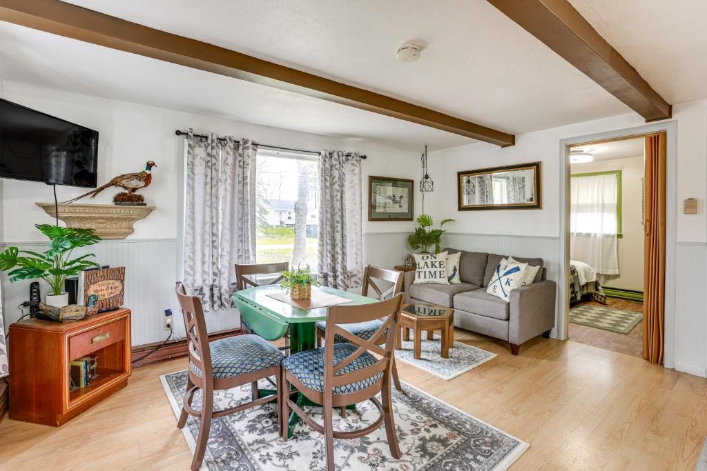 a living room with a table and chairs at Walk to Gray Lake Cozy Pet-Friendly Cottage in Lake