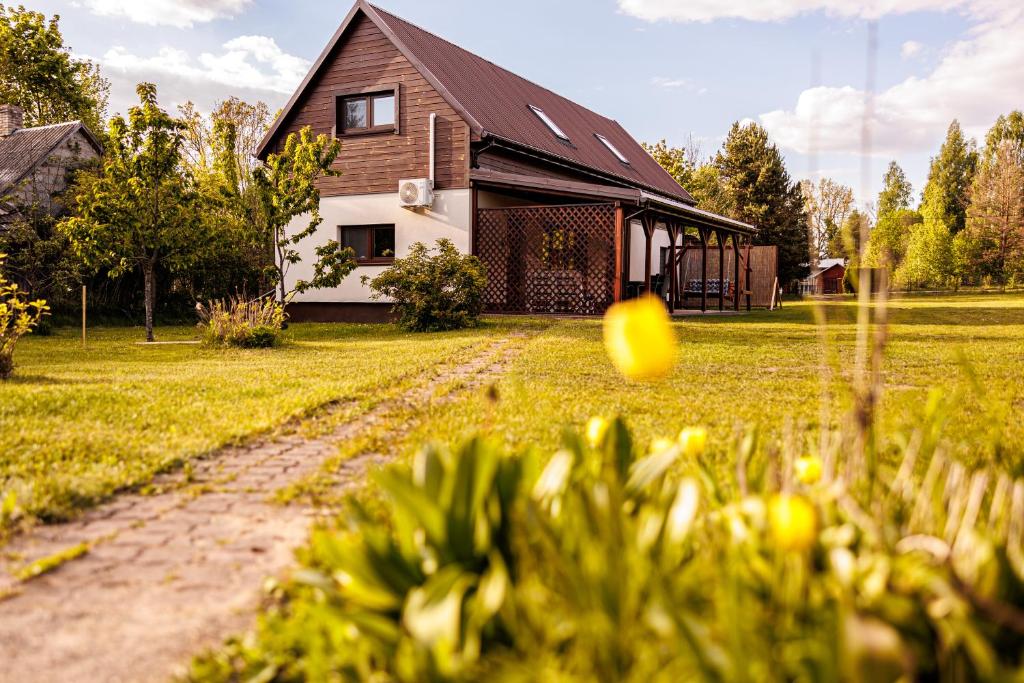 a house with a ball in front of a yard at Wróbelek in Białowieża