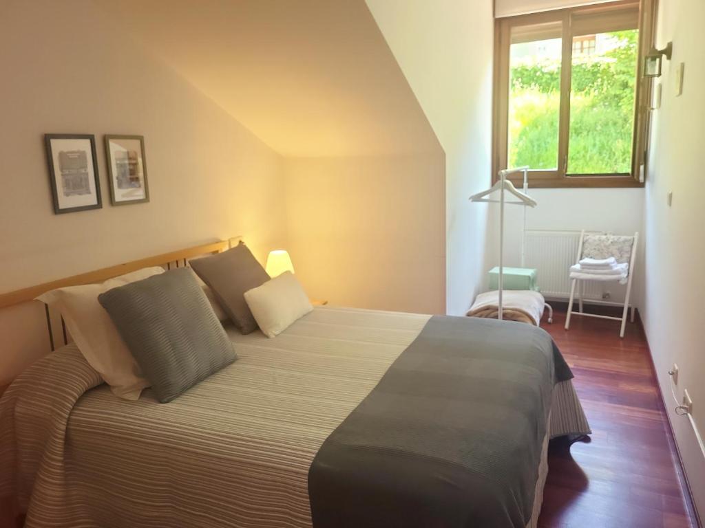 a bedroom with a large bed and a window at Ca Na Martina in Carreña de Cabrales